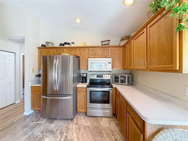 a kitchen with a refrigerator sink and microwave