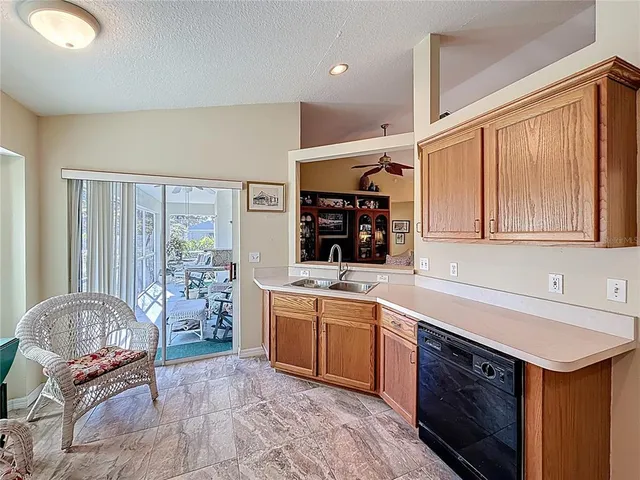a kitchen with a sink cabinets and window