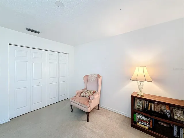 a living room with furniture a lamp and a window