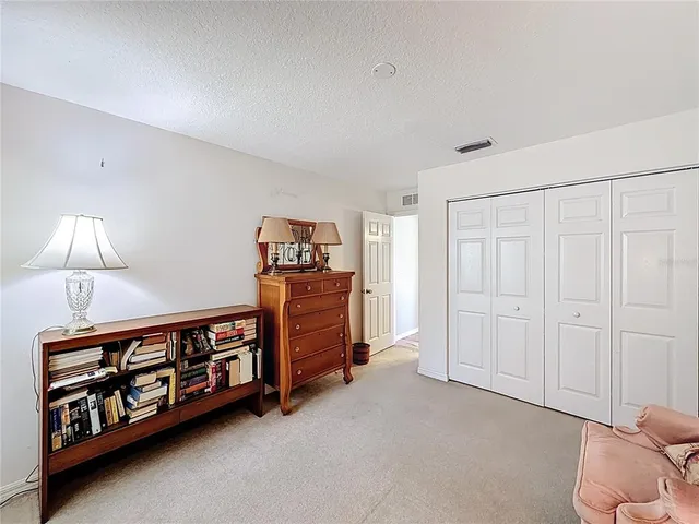 a big room with lots of baby crib and a dresser