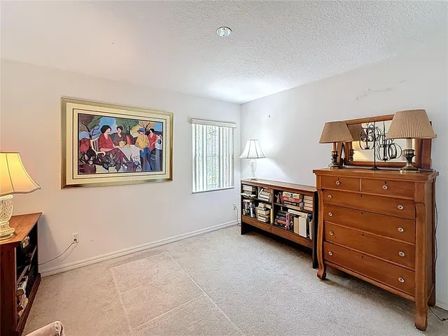 a living room with furniture and a baby crib