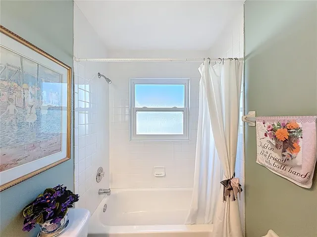 a bath room with a bathtub and a shower