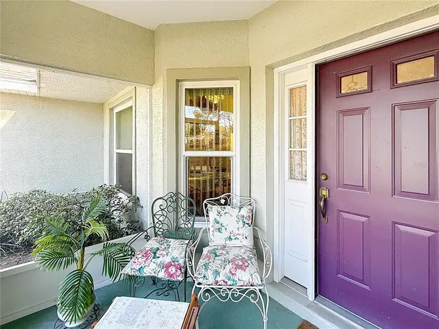 a living room with furniture and potted plant