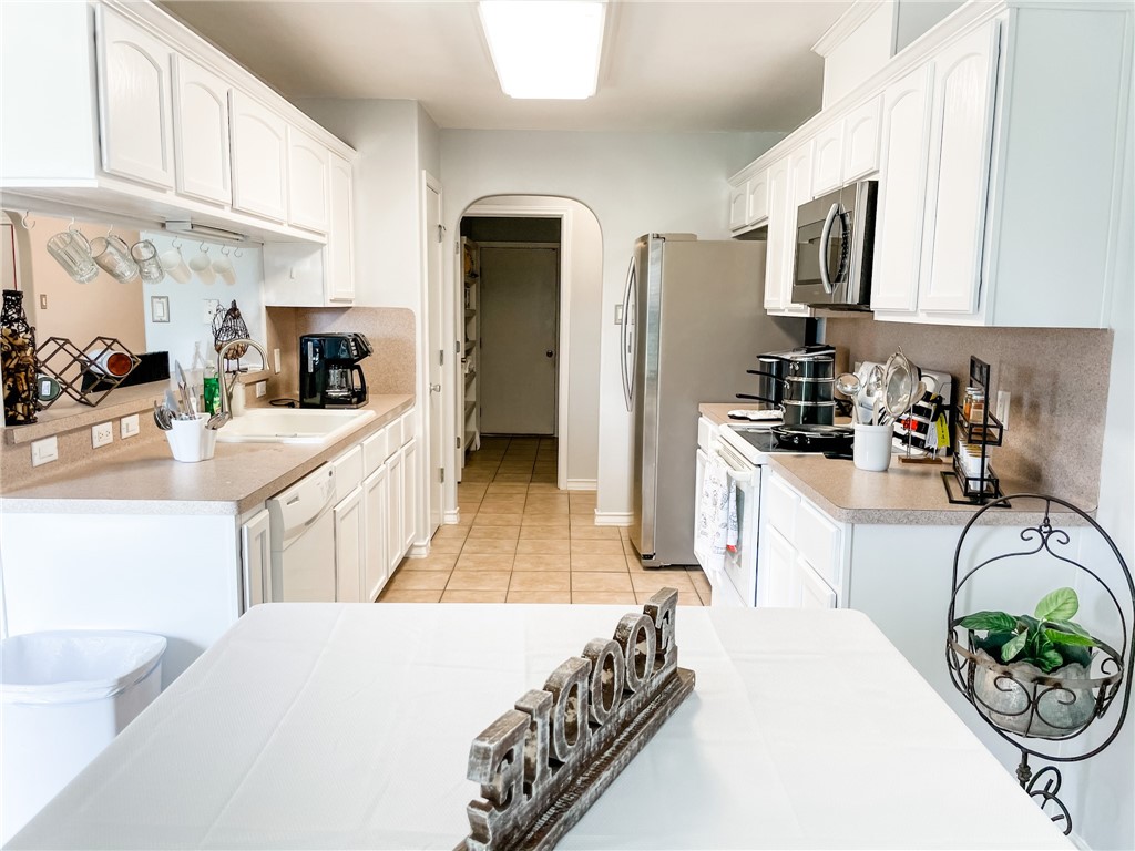 13901 Lighthouse Drive Corpus Christi, TX 78418 - Photo 14 of 38 a kitchen with a sink a stove and cabinets