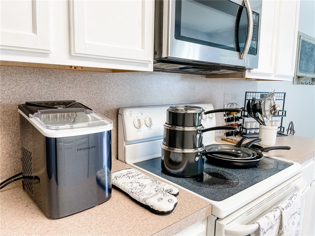13901 Lighthouse Drive Corpus Christi, TX 78418 - Photo 17 of 38 a kitchen with a stove and cabinets