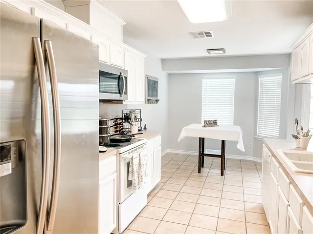 a kitchen with stainless steel appliances a sink stove and refrigerator