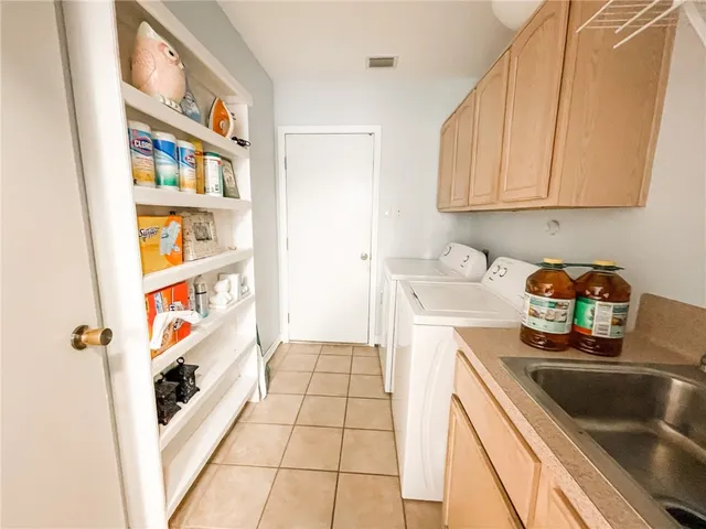 a kitchen with stainless steel appliances a sink a stove and cabinets
