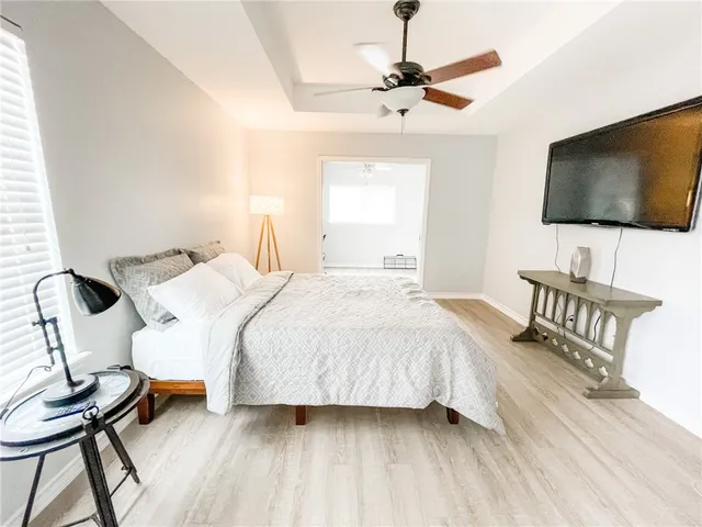 a bedroom with a bed and a flat screen tv