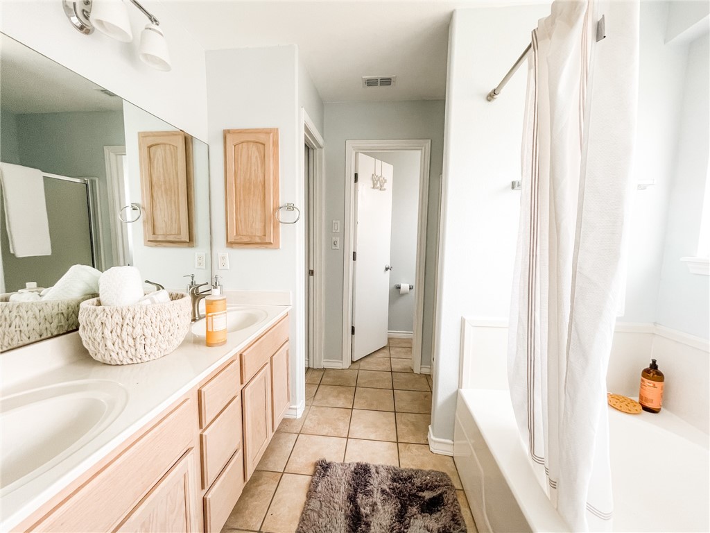 13901 Lighthouse Drive Corpus Christi, TX 78418 - Photo 24 of 38 a bathroom with a tub sink and shower view