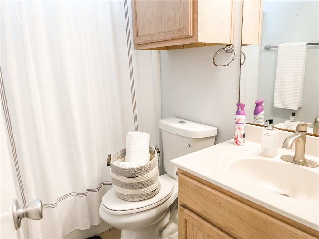 13901 Lighthouse Drive Corpus Christi, TX 78418 - Photo 32 of 38 a bathroom with a sink a toilet and a mirror