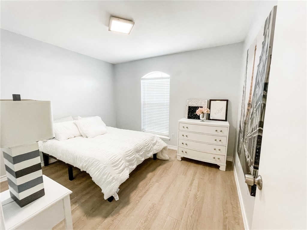 13901 Lighthouse Drive Corpus Christi, TX 78418 - Photo 34 of 38 a bedroom with a bed and wooden floor