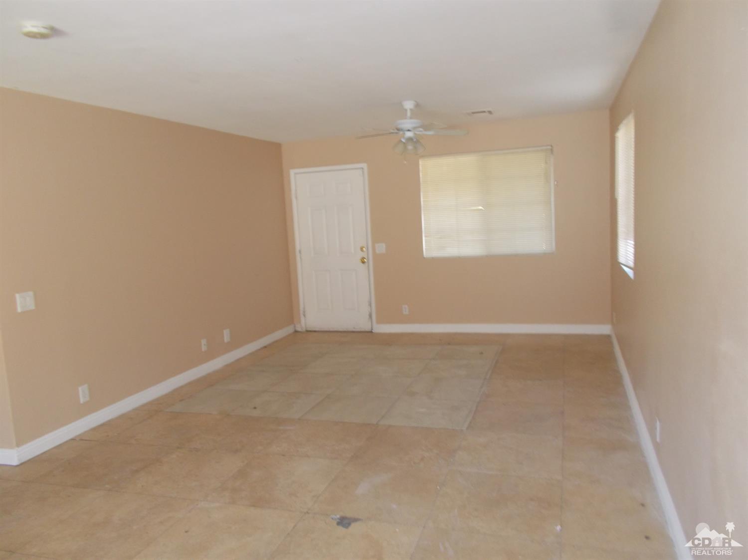 13080 Mountain View Road Desert Hot Springs, CA 92240 - Photo 3 of 11 an empty room with windows