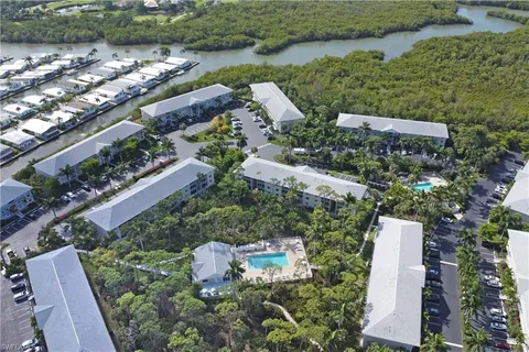 an aerial view of a house with a yard and lake view
