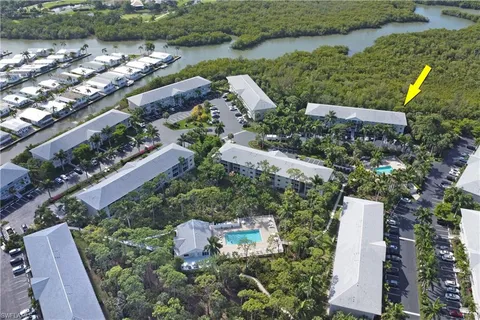 an aerial view of a house with a yard and lake view