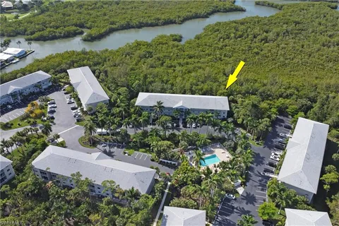 an aerial view of a house with a yard and plants