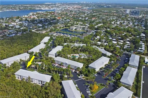 an aerial view of a house with garden space and street view