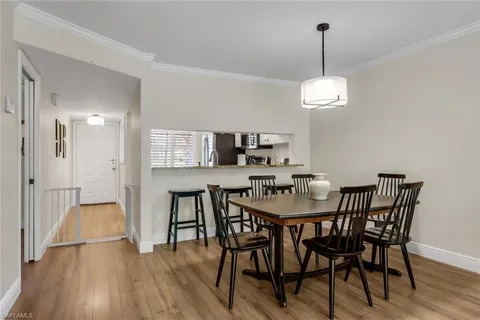 a view of a dining room with furniture wooden floor and chandelier