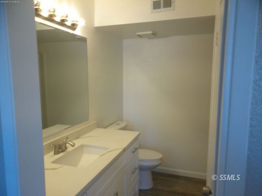 209 South Fire Opal Street Ridgecrest, CA 93555 - Photo 12 of 23 a bathroom with a sink and toilet