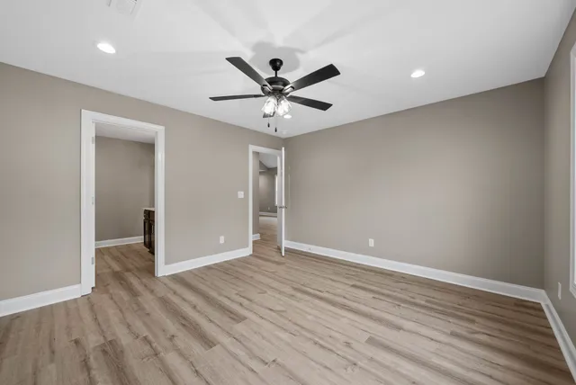a view of an empty room with wooden floor