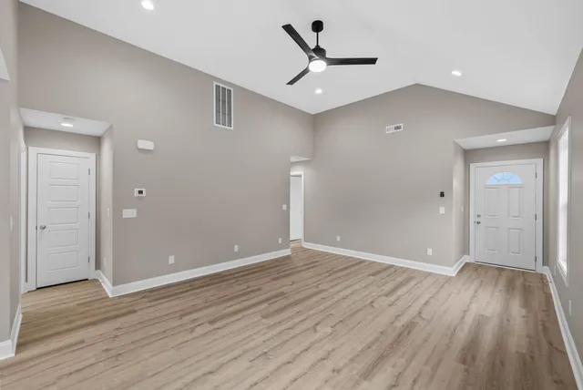 wooden floor in an empty room with a window