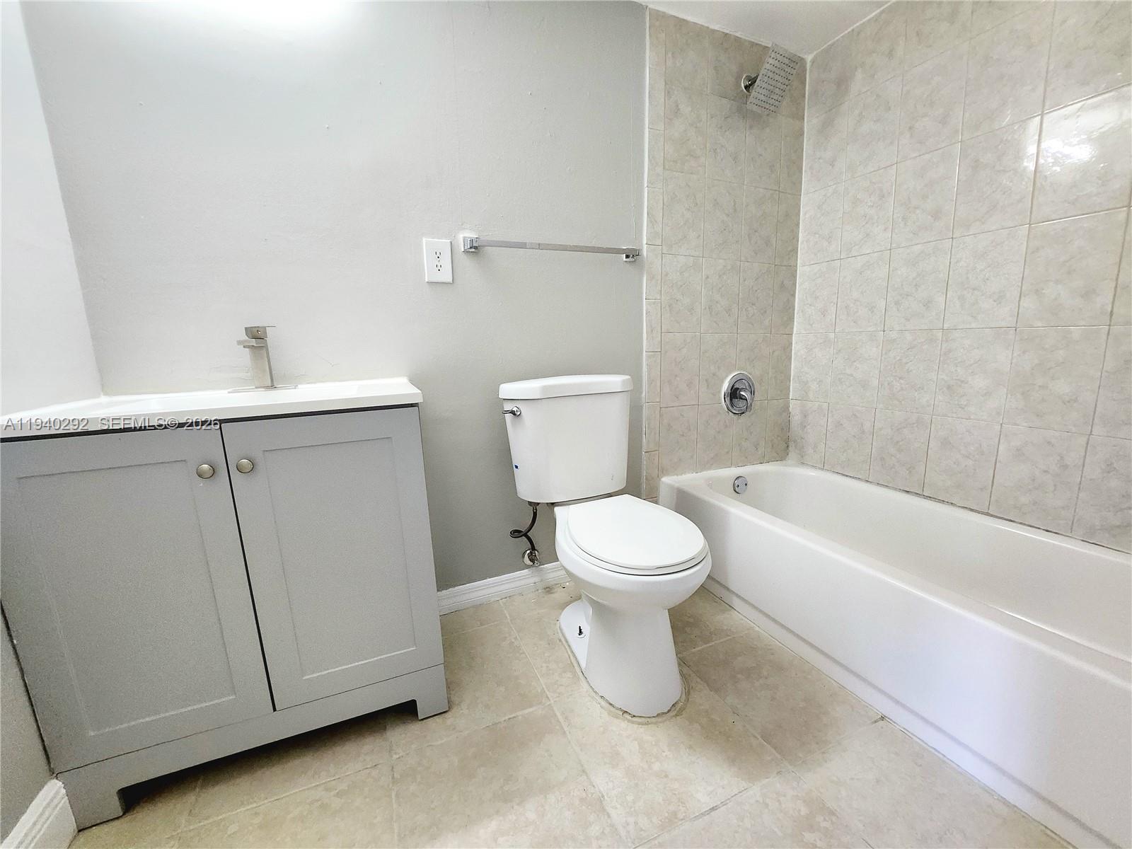 191 Southwest 15th Street, Unit 102 Pompano Beach, FL 33060 - Photo 12 of 12 a white toilet sitting next to a white sink