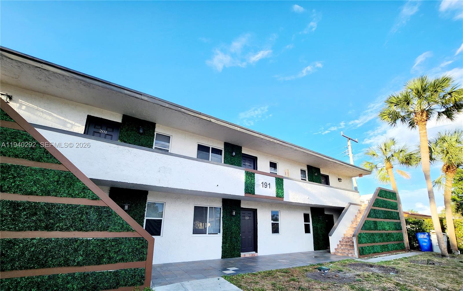 191 Southwest 15th Street, Unit 102 Pompano Beach, FL 33060 - Photo 2 of 12 a front view of a house with a garden
