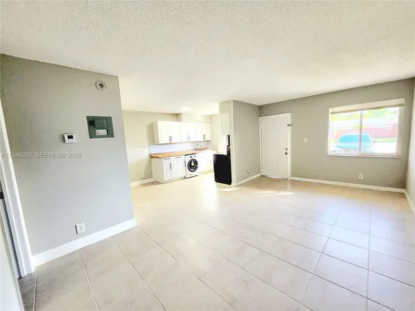 a view of a kitchen with a sink and a refrigerator