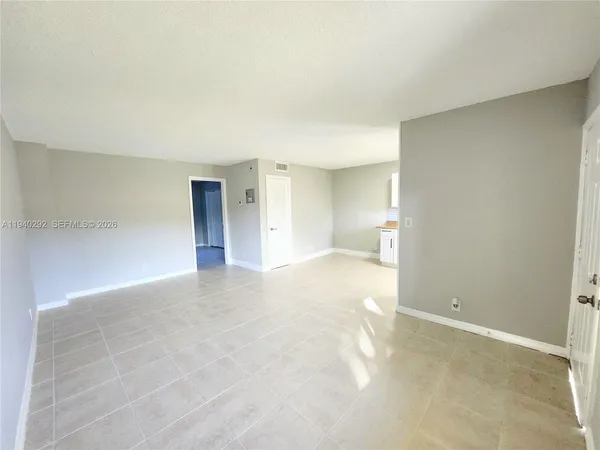 a view of an empty room with a bathroom