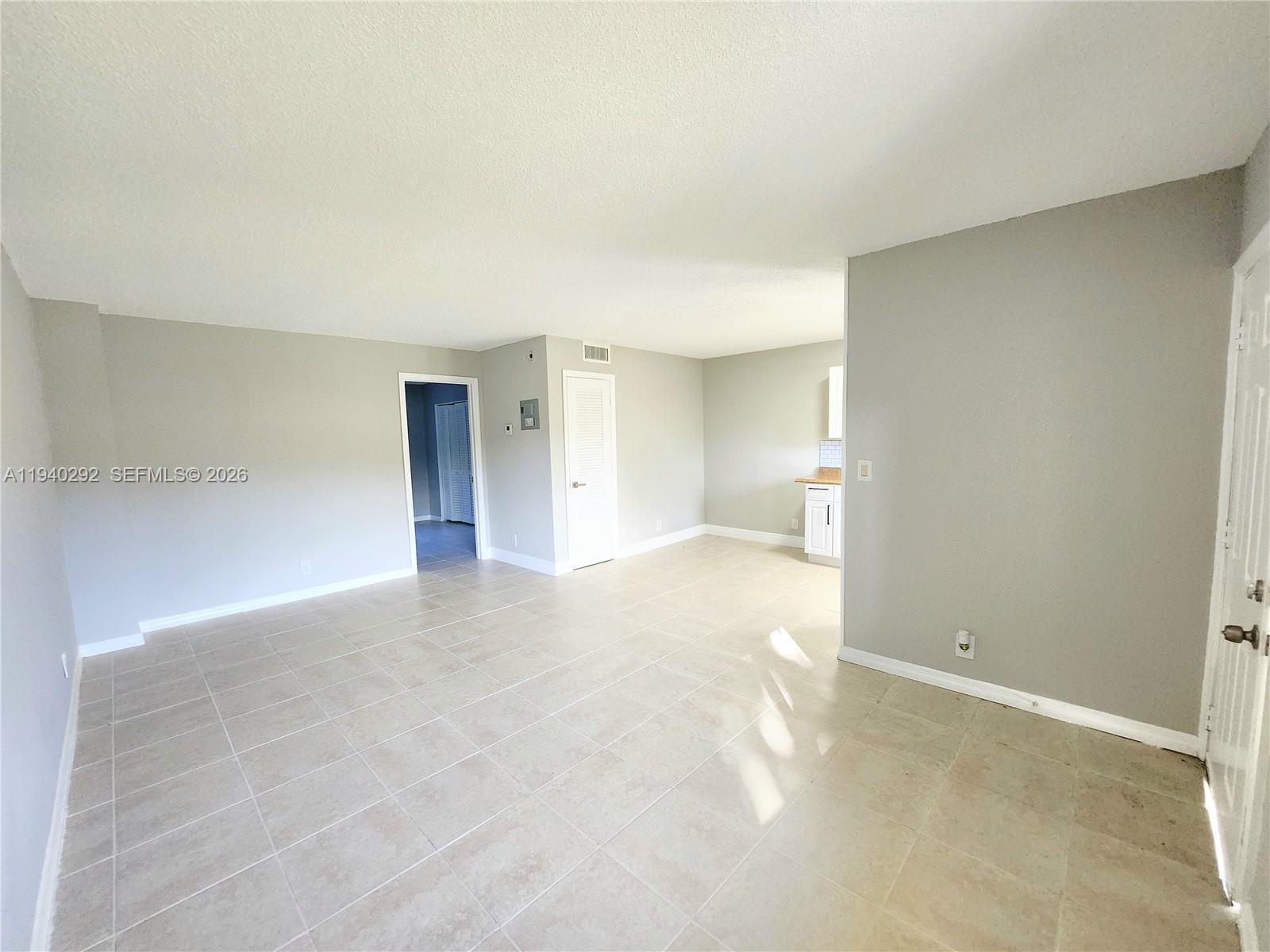 191 Southwest 15th Street, Unit 102 Pompano Beach, FL 33060 - Photo 7 of 12 a view of an empty room with a bathroom