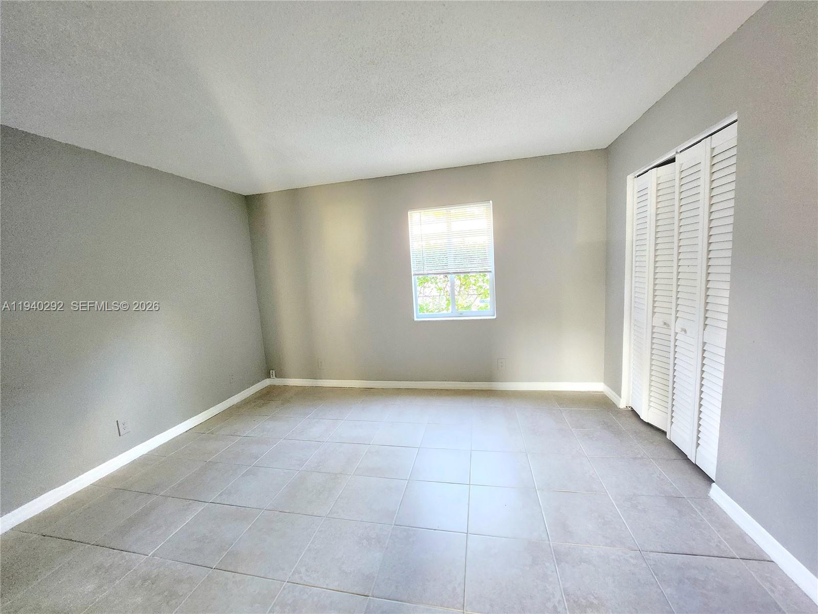 191 Southwest 15th Street, Unit 102 Pompano Beach, FL 33060 - Photo 10 of 12 a view of an empty room with a window
