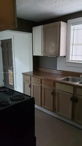 a kitchen with a sink and a stove