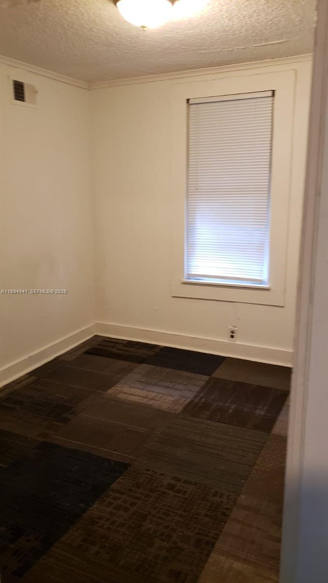 1517 Logan Street Jacksonville, FL 32209 - Photo 9 of 30 a view of a small space with wooden floor and a window