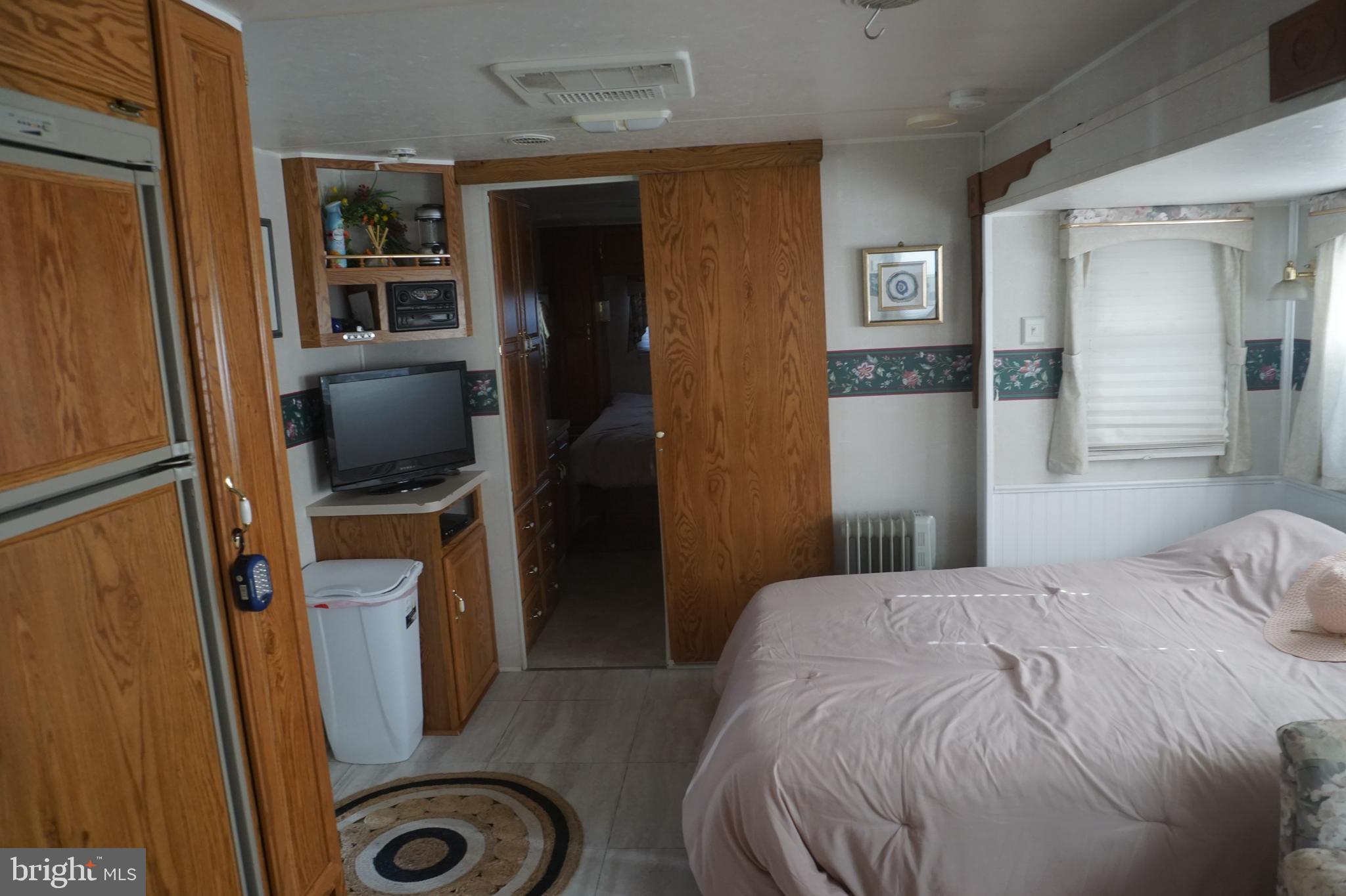 69 Block Falling Waters, WV 25419 - Photo 13 of 14 a bedroom with a bed and a flat screen tv