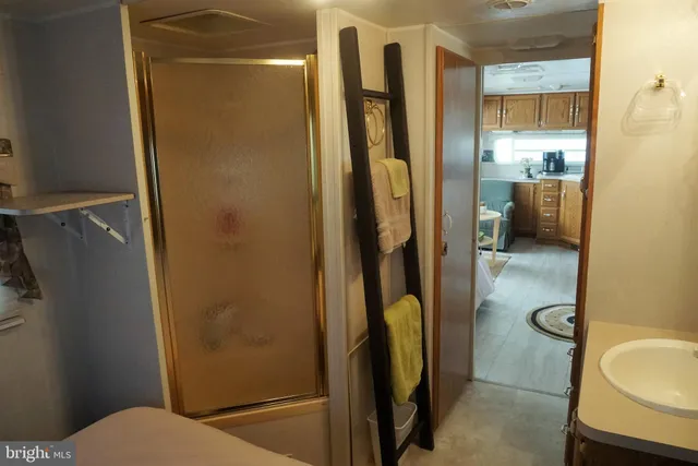 a bathroom with a granite countertop shower and a toilet