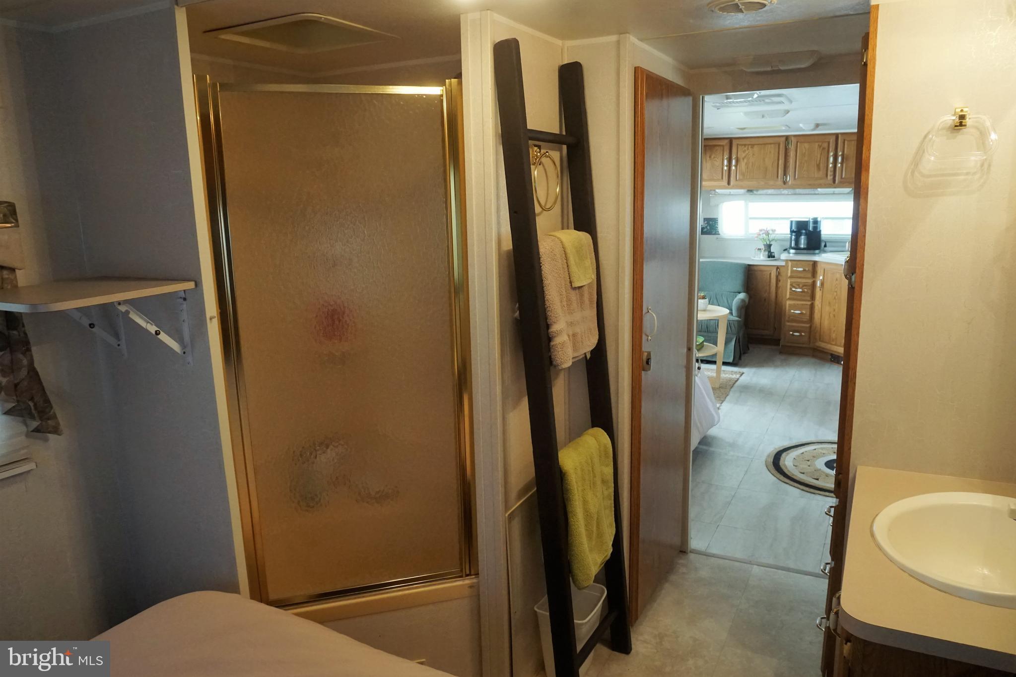 69 Block Falling Waters, WV 25419 - Photo 10 of 14 a bathroom with a granite countertop shower and a toilet