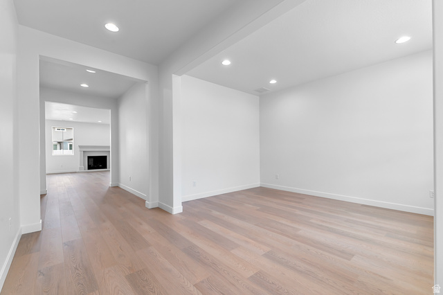 1869 South 2425 West Ogden, UT 84401 - Photo 5 of 22 Spare room with a fireplace, recessed lighting, and light wood-type flooring