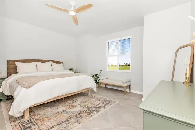 a bedroom with a bed and a potted plant