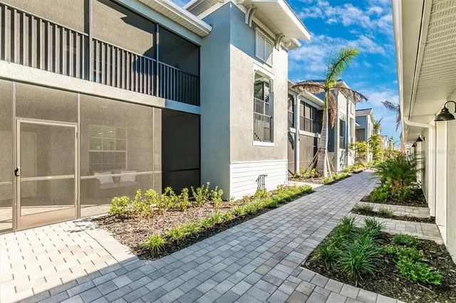a building outdoor space with patio furniture and potted plants