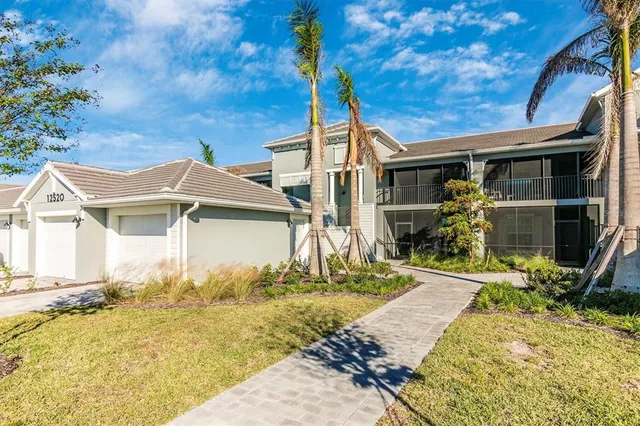 a front view of a house with glass windows and furniture