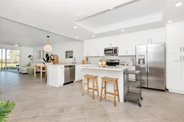 a kitchen with a sink cabinets and appliances