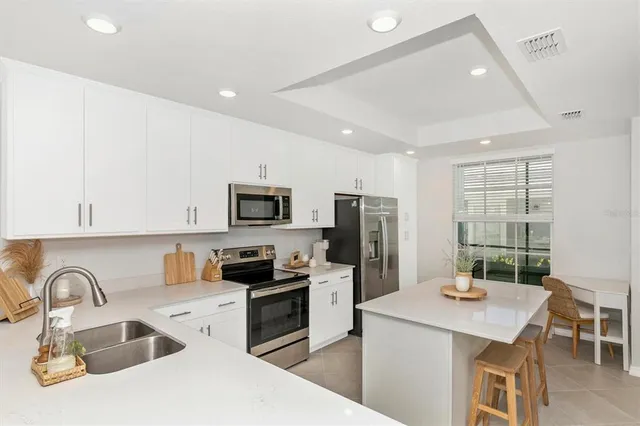 a living room with furniture a window and a flat screen tv