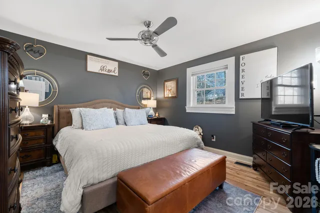 a bed room with a bed window and a flat tv screen