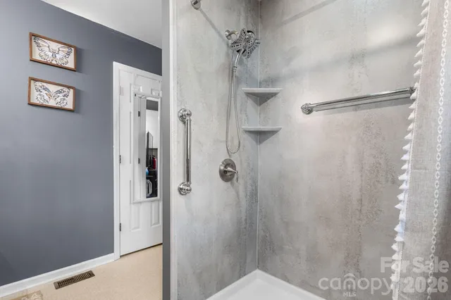 a bathroom with a shower and a sink