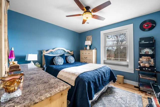 a bedroom with bed and a window