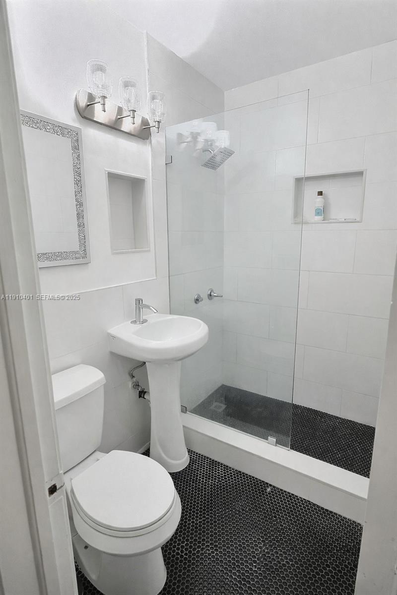 6541 Southwest 18th Street Miami, FL 33155 - Photo 12 of 22 a bathroom with a sink toilet and shower
