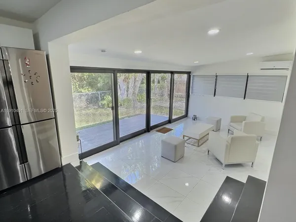 a large white kitchen with a large window