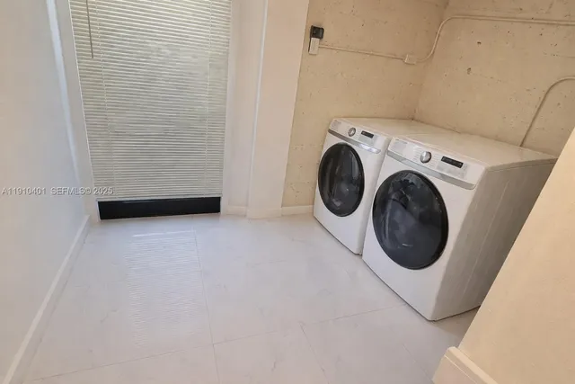 a view of a storage & utility room with dryer and washer