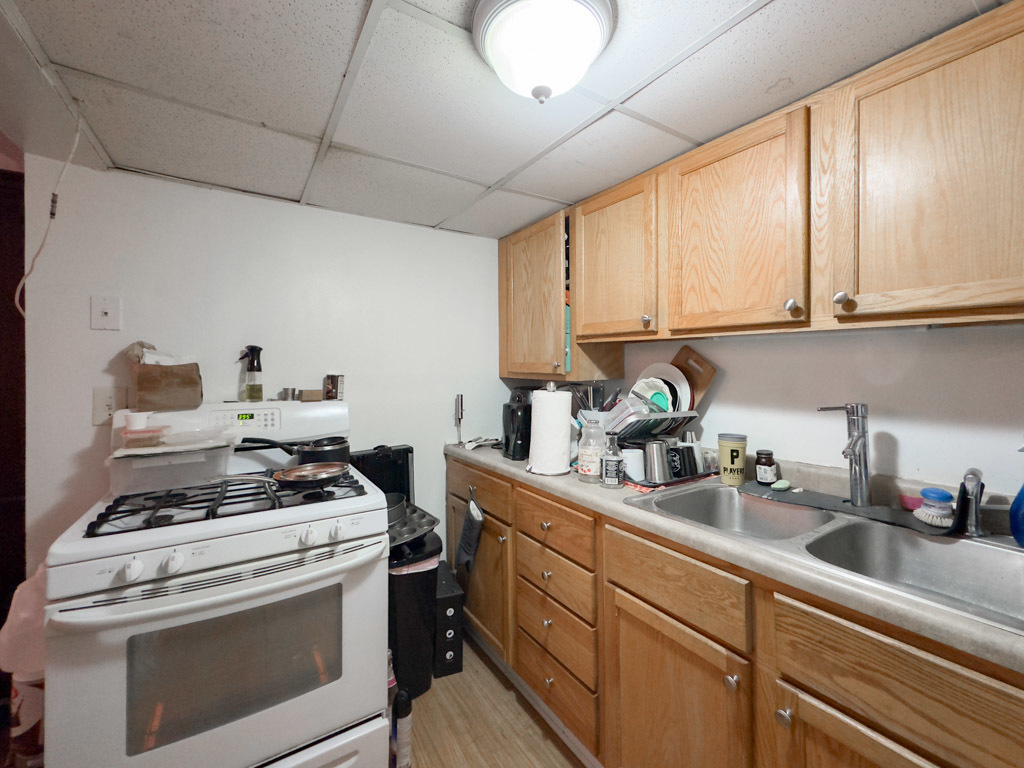 3701 North Racine Avenue, Unit GE Chicago, IL 60613 - Photo 3 of 20 a kitchen with stainless steel appliances granite countertop a sink a stove and cabinets