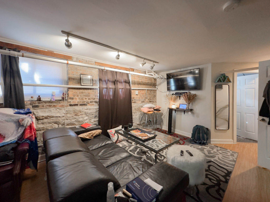 3701 North Racine Avenue, Unit GE Chicago, IL 60613 - Photo 7 of 20 a view of a dining room with furniture and a flat screen tv