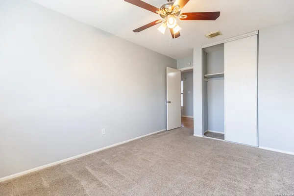 a view of an empty room with a fan